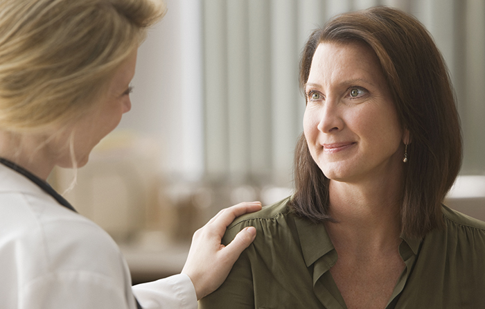 Doctor with hand on patient's shoulder